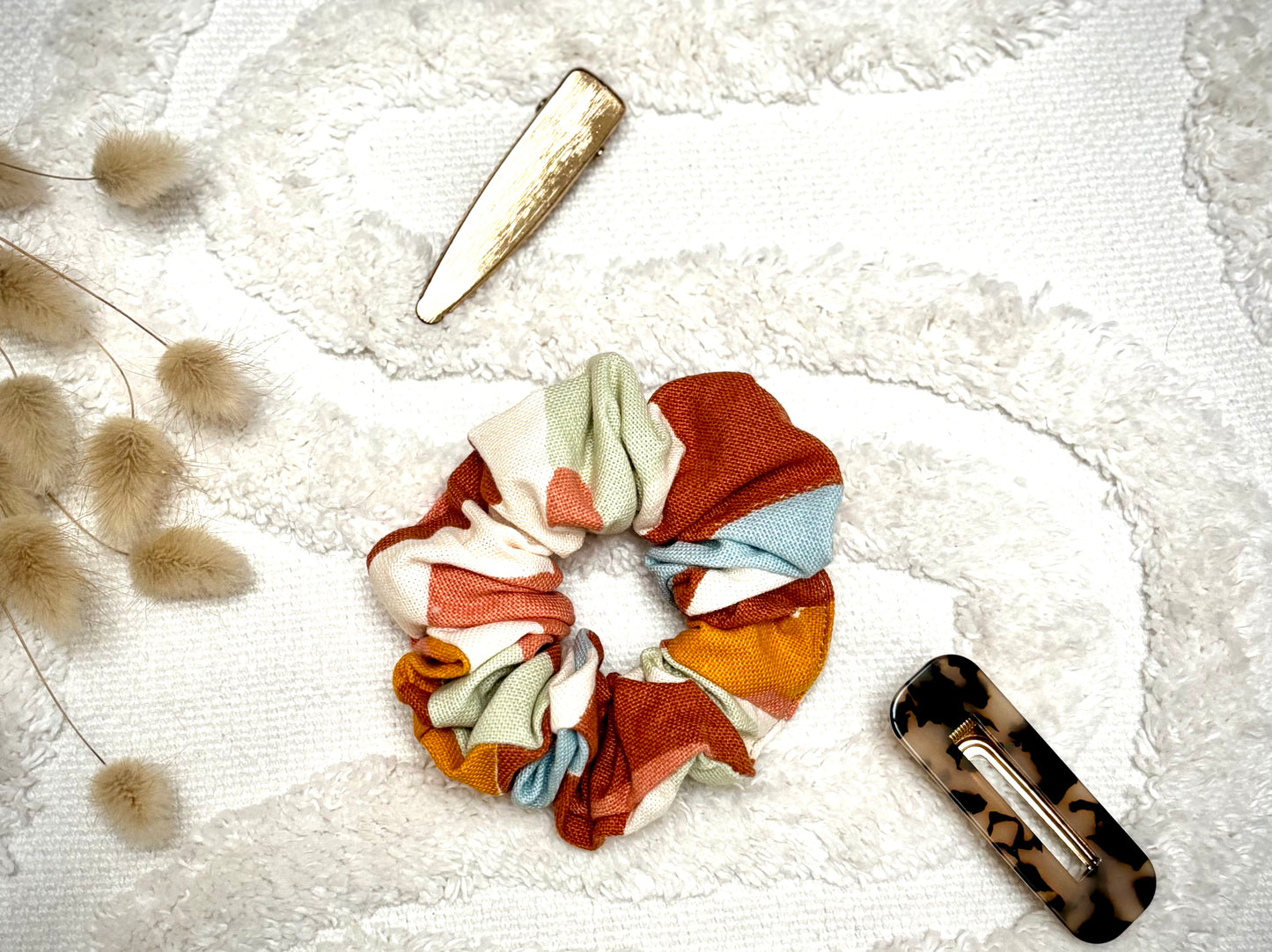 Chouchou bijou Bohémia en tissu texturé, accessoire élégant et pratique pour cheveux ou poignet.